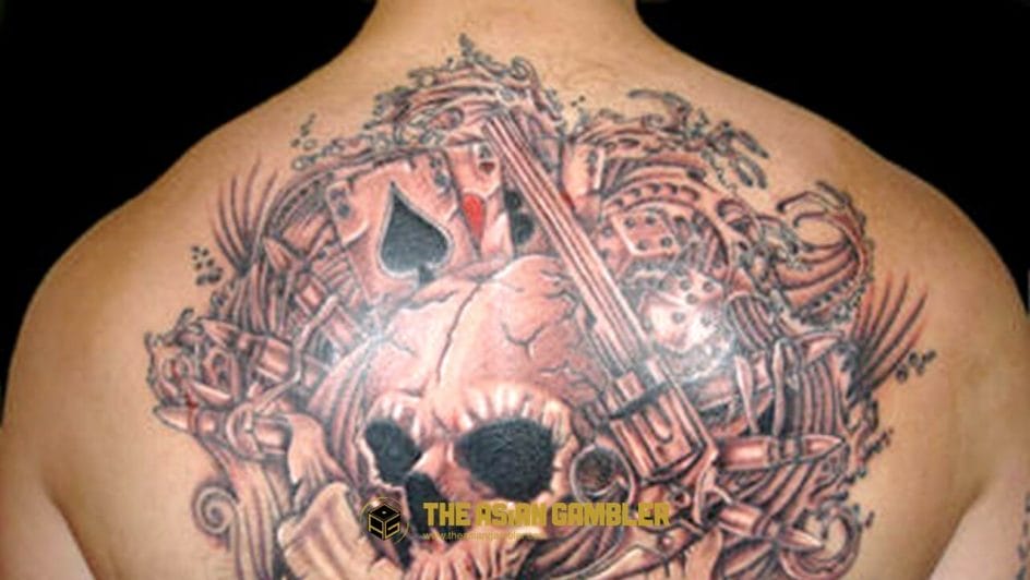 gambling-themed tattoo on the back of the body